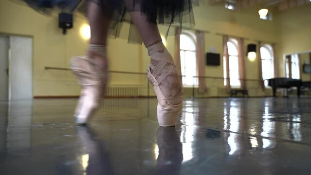 Ballerina training in pointe shoes in the ballroom 4k