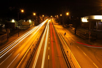 Fototapeta na wymiar Long exposure of car light trails on a city street at night