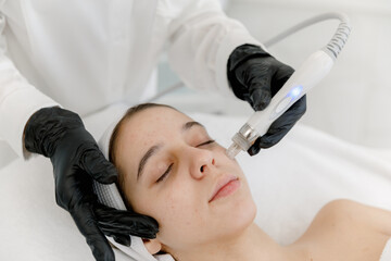 Vacuum facial cleansing woman's face. Teen skin. Hydra peeling. 