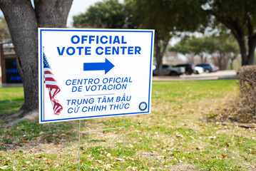 Official Vote Center yard sign with stake in English, Spanish, Vietnamese languages to welcome resident and non-English-proficient groups to voting location at elementary school in Dallas, Texas