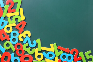 Colorful numbers on green background, flat lay. Space for text