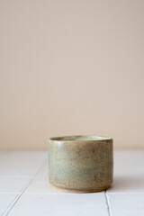 empty handmade ceramic coffee cup on beige background