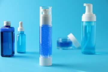 Different cosmetic products on light blue background