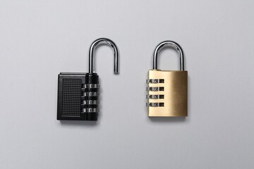 Steel combination padlocks on grey background, top view