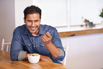 Portrait, smile and man eating fruit salad in home at table for healthy diet, nutrition or wellness at breakfast in the morning. Face, happy person and hungry for food, yogurt or organic strawberry - obrazy, fototapety, plakaty