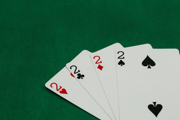 A pile of Poker playing card, playing cards on green background.;