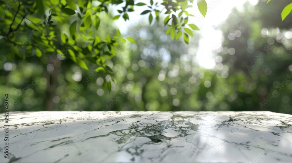 Poster bright sunlight shining on an empty white table with a bokeh effect of green leaves.