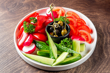 Plate with sliced vegetables, vegetarian snacks