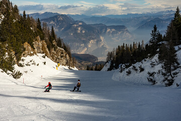 Family ride snowboarding. Ski resort Paganella Andalo, Trentino-Alto Adige, Italy. Ski slopes and...