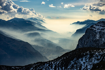 Lake garda view in  Trentino-Alto Adige, Italy. Ski slopes and snow holidays in Andalo in the Italian Dolomites, ski resort in the Alps. Snow covered Italian Dolomites at winter. - obrazy, fototapety, plakaty