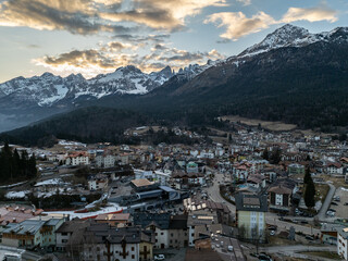 Aerial drone view of Andalo town with mountains background in winter. Snow covered Italian...