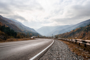 Fototapeta premium background mountain road and sky with clouds in the afternoon in Georgia
