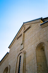 Fototapeta na wymiar modern christian church with a cross on the wall in Georgia