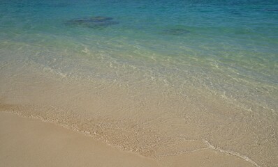 Fototapeta na wymiar Lanikai Beach's clear, clean ocean and sandy beach