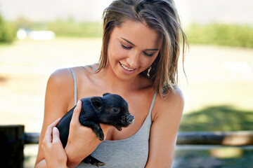 Woman, pig and happiness for wellness, charity organization and rescue center. Volunteer, smile and...