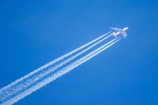 Emirates Airbus A380-800 airplane with contrails over Munich Airport in Germany