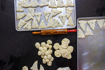 preparing arabic traditional pastries by female hands stuffing them with spinach and red chili