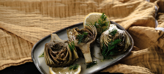 baby artichoke cooked with olive oil and greens, popular springtime mediterranean kitchen starter...