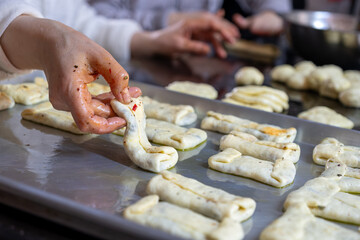preparing arabic traditional pastries by female hands stuffing them with spinach and red chili