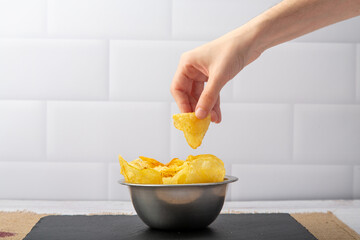 A hand reaching for thin-cut fries, capturing the anticipation of crispy delight and savory...