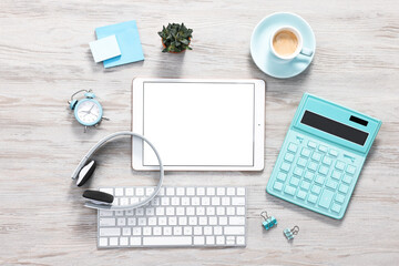 Flat lay composition with modern tablet on white wooden table. Space for text