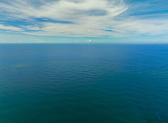 Aerial view of beautiful deep blue sea with waves and sky with clouds, seascape. Mindanao, Philippines.