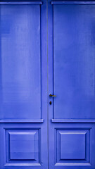 Picturesque blue wooden door of a house in the village of Cadaques, Costa Brava, Girona, Spain