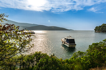 Boat anchoring in a beautiful bay (Osor) on the island of Cres-Losinj in the Adriatic Sea, Croatia