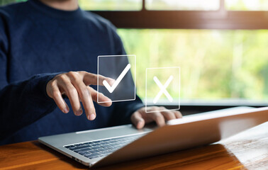 Select the check mark on a laptop. check right and wrong marks. concept decide to choose vote. yes...
