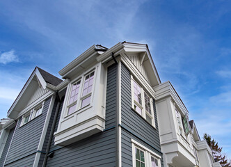 Top of residential townhouse on blue sky background