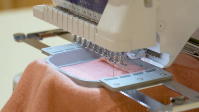 Automatic sewing machine for embroidering patterns and designs on clothes using computer technology.