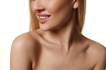 Obraz na płótnie Canvas Close-up cropped image of blonde young woman with bare shoulders and neck visible isolated against white studio background. Concept of natural beauty, cosmetology, cosmetics, skin care and health