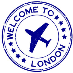 Grunge blue welcome to london with airplane icon round rubber seal stamp on white background