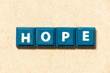 Obraz premium Tile alphabet letter in word hope on wood background