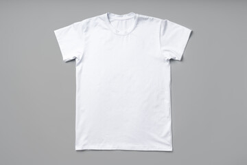 Cotton T-shirt on gray background flat lay top view