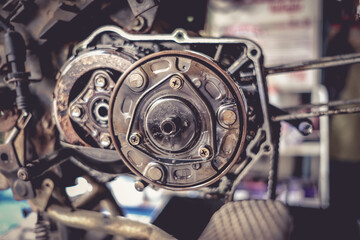 Motorcycle mechanics are assembling the motorcycle engine clutch assembly and maintenance.	