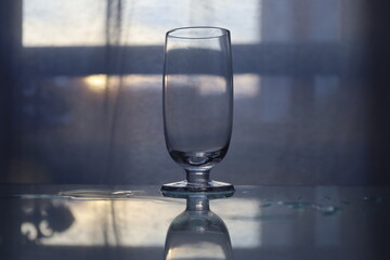 closeup  glass on wet reflective surface