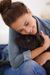 Dog, woman and hug with smile for animal, pet and together indoor for bonding, affection and...