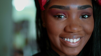 One joyful black latina adult girl in 20s smiling at camera. Portrait of South American young woman...