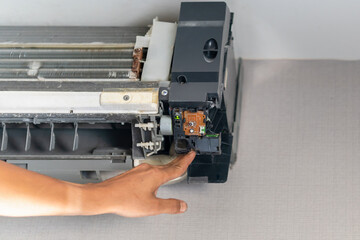 Hands of technician checking thermistor, Repairman fixing air conditioning system, Technician service for repair and maintenance of air conditioners