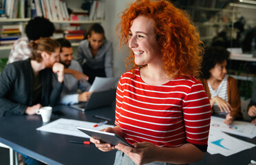 Success happy business woman using tablet computer and working. Designer, manager in her office