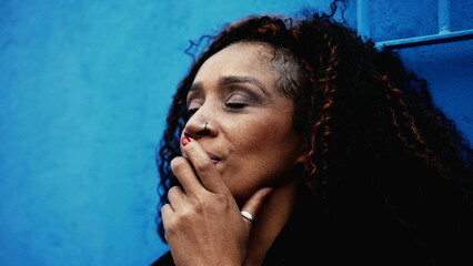 One pensive woman in 50s struggling with regrets and past mistakes, contemplative African American lady feeling overwhelmed by anxiety and problems