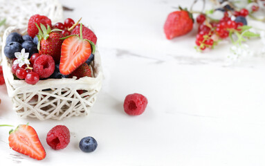 fresh berries raspberries strawberries currants on a wooden table