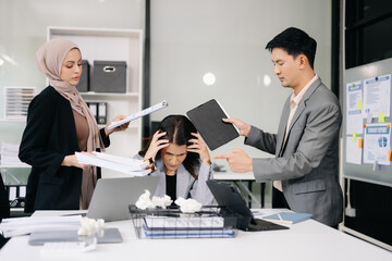 Stressed Asian Businesswoman Surrounded by Overwhelming Paperwork Concept of Workplace Anxiety and Overwork