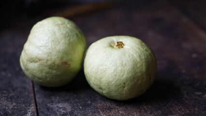 two guavas on a wooden background
