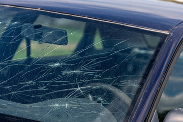 Obraz premium Broken windshield on a car. Damaged glass on a car.