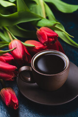 a cup of coffee and a bouquet of tulips
