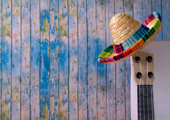Mexican composition with copy space. Guitar and sombrero hat on blue background. Stereotypical attributes of Mexican culture. Celebrating Cinco de Mayo - 752327086