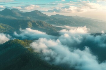 Munnar mountain landscape with flowing fog and clouds at sunrise