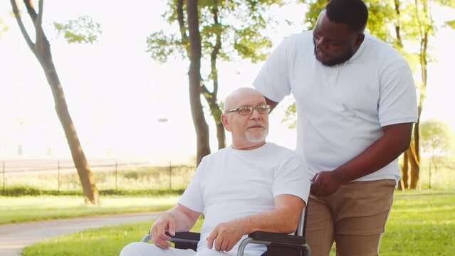 African-American caregiver and old man. Professional nurse and patient in a nursing home. Assistance, rehabilitation and health care concept.